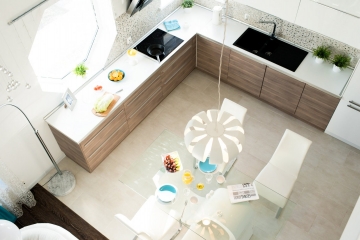 High angle view of modern kitchen interior in cozy apartment lit by sunlight, copy space, no people